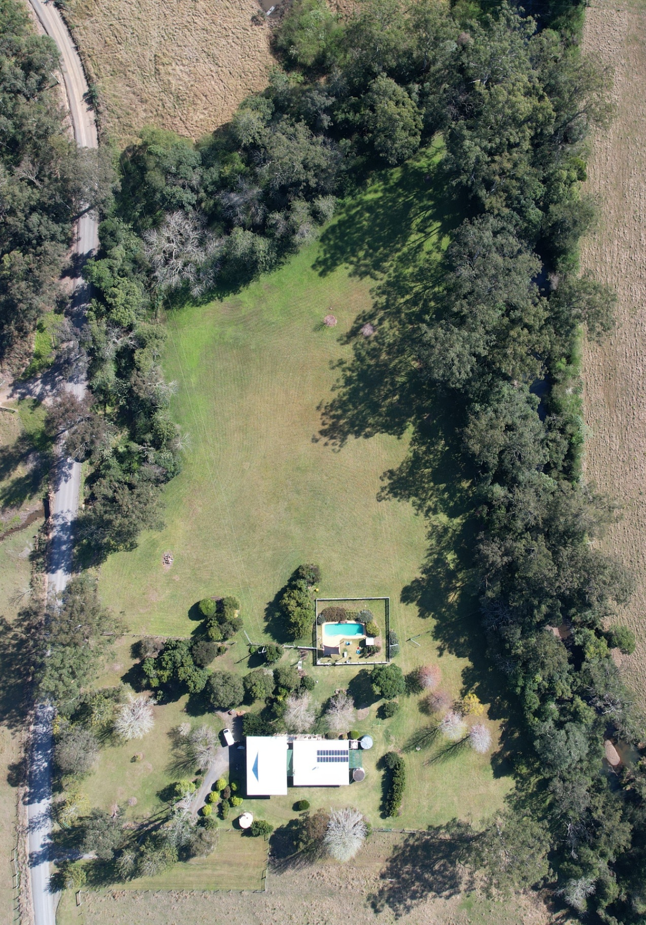Aerial down the valley showing road approach and outbuildings